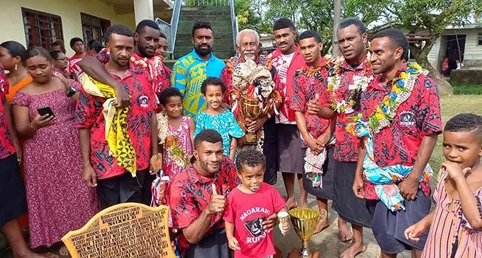 Kinoya villagers with Fijian Drua players Onisi Ratave and Vinaya Habosi while celebrating Naqarani’s Digicel Koroturaga Cup win. Photo: Ronald Kumar.