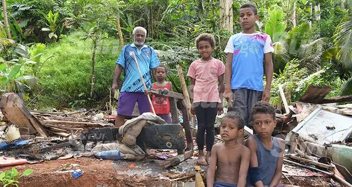 Viliame Koroi 69 walk in the ruins of house with children after his house was dismantled and they were given eviction notice in Tamavua on December 11, 2019. Photo: Ronald Kumar.