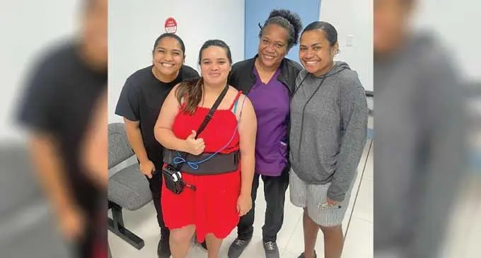 A pioneer patient at PSH with hospital staff showing the belt that is worn and records images taken by the Pill Cam. Photo: Pacific Specialists Healthcare