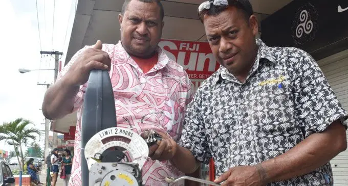 Staff of Nadi Town Council Serevi Vula (left), with technician Samisoni Nakuwe working on the manual parking machines. Photo: Waisea Nasokia