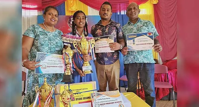 Avantika Ryana Sharma with her family during Togo Primary School prize giving ceremony in Nadi on Friday. Photo: Waisea Nasokia