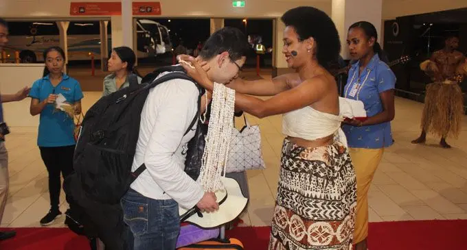 Alesi Kunara of Tour Managers greeting one of the Chinese visitors at Nadi International Airport.