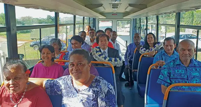 The Counsellor and Deputy Chief of Mission from the Embassy of Japan, Tanaka Kenichiro and the Minister for Women, Children and Poverty  Alleviation, Rosy Akbar amongst the residents and workers of the Golden Age Home of Natabua, Lautoka inside the new bus outside the Western Disability Centre on June 15, 2022.  Photo: Nicolette  Chambers