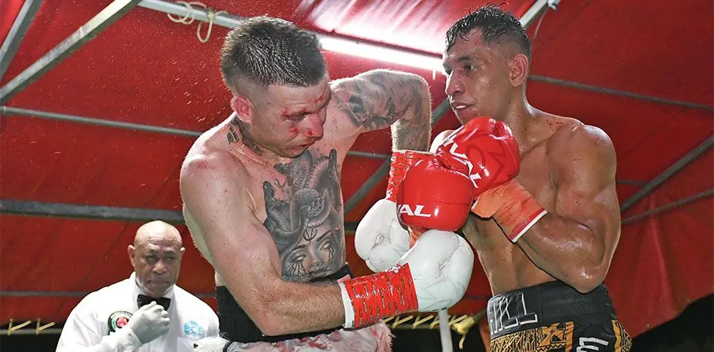 From left: A bloodied Jyl Wright of Australia is unable to defend himself against Fiji's Winston Hill at Prince Charles Park in Nadi on May 18, 2024. Hill won on an eighth round TKO to claim the IBO Asia Pacific super welterweight title. Photo: Waisea Nasokia 
