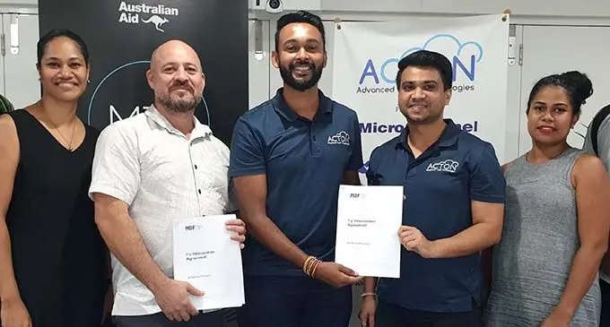From left: Market Development Facility (Fiji) staff, Marilyn Vilisoni, MDF Fiji Country Director, Malcolm Bossley, ACTON Director, Sanjesh Kumar,  ACTON staff member Mukesh Lodhia, MDF staff Makelesi Raibe  following the signing of the partnership agreement