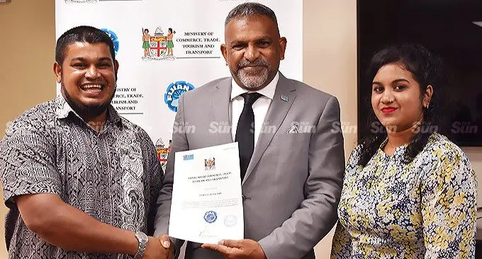 Minister for Commerce and Trade Faiyaz Kaya flanked by Ziyaad Hussein and his siter Saliha Hussein on June 2, 2022. Photo: Frederica Elbourne.