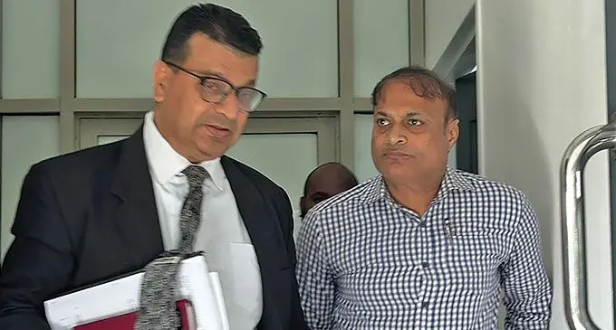 Former Post Fiji chief executive officer Anirudha Bansod with his counsel Davenesh Sharma outside the Magistrate Court in Suva on July 29, 2024. Photo: Wati Talebula-Nuku