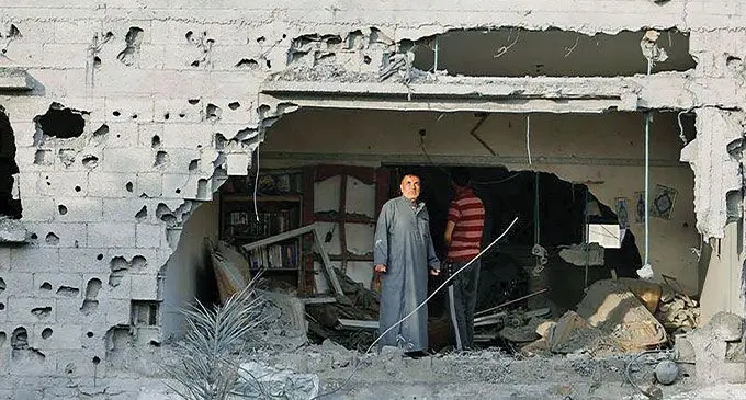 Palestinians inspect damage at a home after an Israeli airstrike amid the Israel-Gaza fighting in Deir al-Balah Town in the central Gaza Strip on May 13, 2023. Photo: Reuters