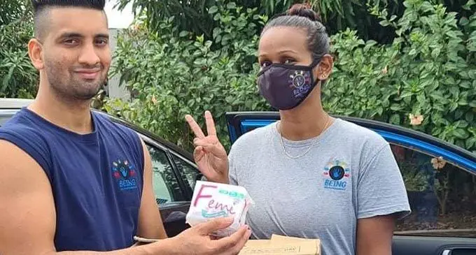 Fit Chef creator, Zunaid Khan handing over the box of sanitary pads to the Being Helping Hands Fiji Nadi co-ordinator, Vimo Keshwal.