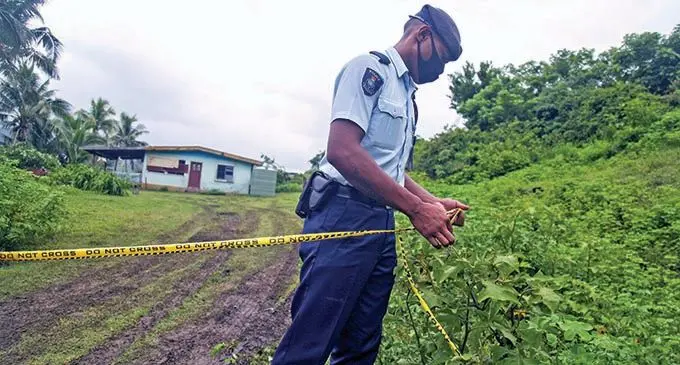A Police officer outside the house where four people were found dead at Volivoli in Rakiraki on January 6, 2022. Photo: Leon Lord