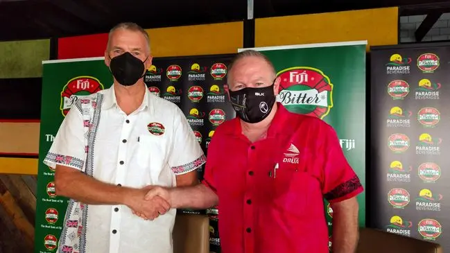Pacific Beverages general manager Mike Spencer (left) seals the deal with a handshake with Fijian Drua interim chief executive officer Brian Thorburn at the Paradise Beverages Staff & Bar Canteen, Walu Bay in Suva on January 19, 2022. Photo: Simione Haravanua