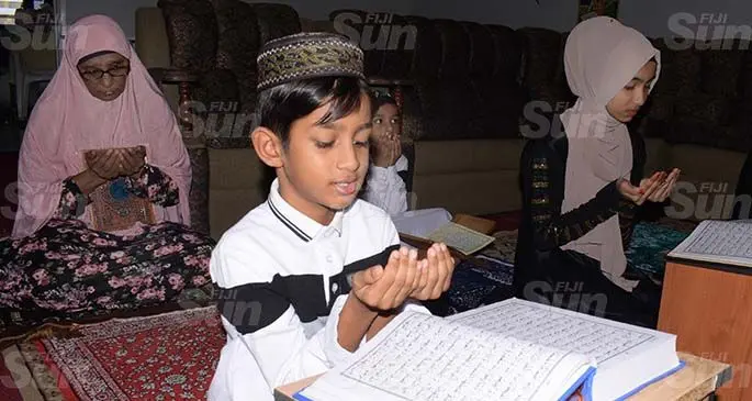 From left-Nasra Begam 65 prayer with her grandchildren Ubaid Shakir 8, Usaid Shakir 5 and Raba Ishrat 14 at their Samabula home on April 24, 2020. Photo: Ronald Kumar.