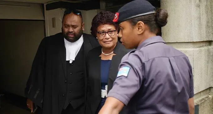 Lawyer, Simione Valenitabua, with his client and former SODELPA MP Salote Radrodro as she is escorted by a Police officer following her sentencing outside the court house in Suva on September 22, 2022. Photo: Ronald Kumar