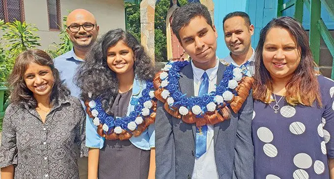 Parents of the St Teresas Primary School head girl Hetvi Lad and head boy, Efrem Douglas with their parents. From left: Vaishali Lad, Viraaj Lad, Christopher Douglas and Shavannah Douglas on April 27, 2022.   Photo: Nicolette Chambers