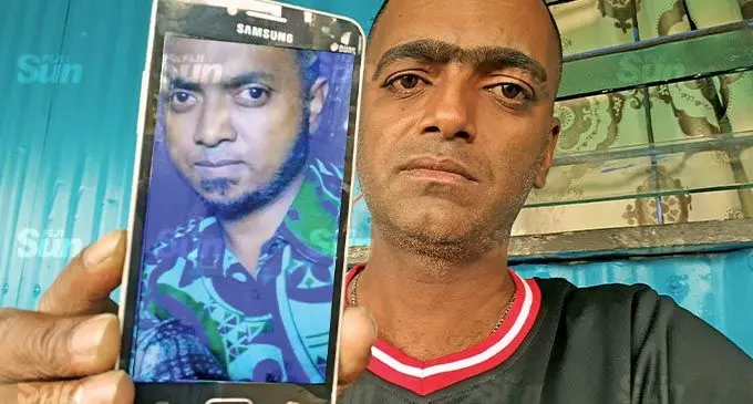 Deepak Chandra holds a mobile photo of his missing brother, Sanil Chandra. Photo: Ronald Kumar