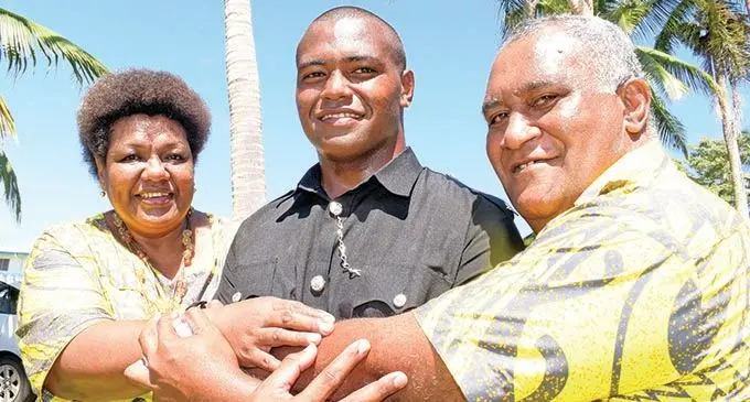 Proud parents, Pita and Salute hug their elders son, Isikeli Lomelume 21 following the Police basic recruit passout parade at Nasova ground on September 11, 2020. Photo: Ronald Kumar.