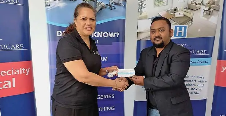 PSH managing director Parvish Kumar presenting the cheque to Wows Kids chairperson and co-founder Sina Kami in Nadi. Photo: Charles Chambers