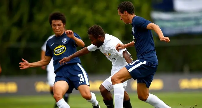 Solomon islands football captain Henry Fa’arodo (middle) dribbles past the Team Wellington defenders. Photo: Zimbio