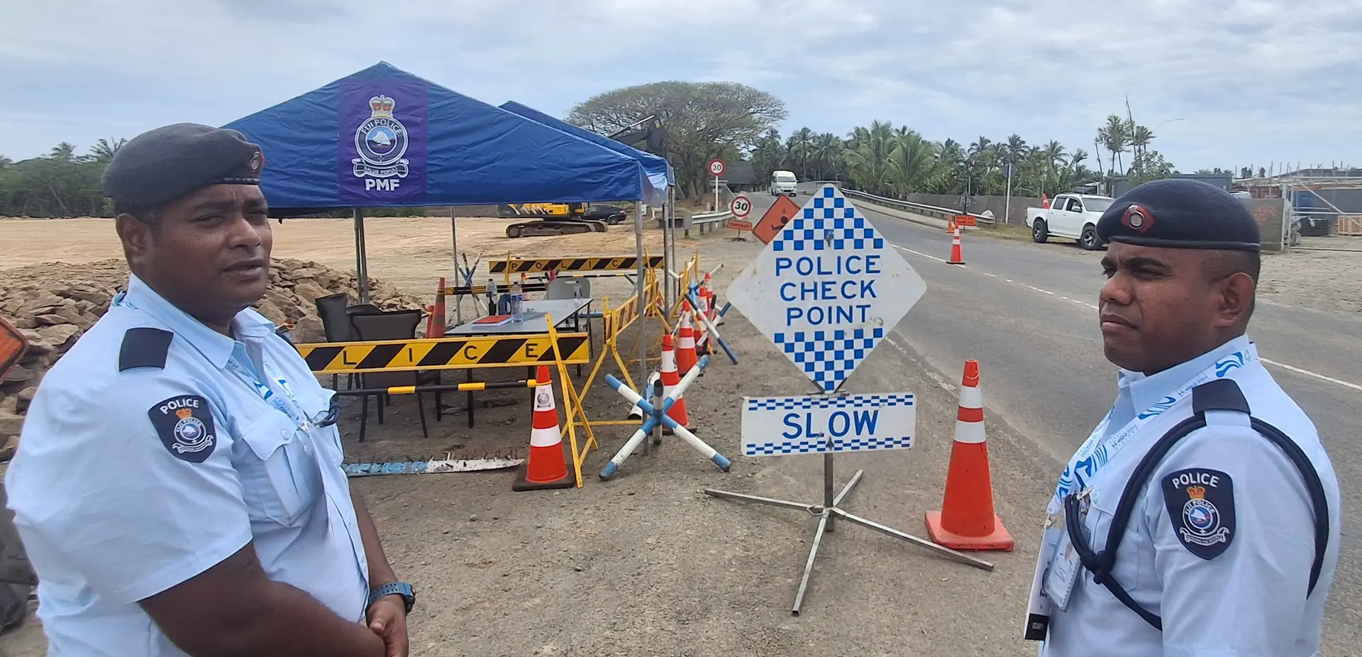  Police constable Timoci Bebe with police constable Maloni Vakacavu at the police checkpoint before the Denarau Bridge. 