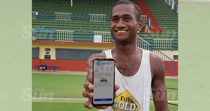 Sivo Lote holds up his phone with the careFiji application at Churchill Park in Lautoka on August 5, 2020. Photo: Salote Qalubau