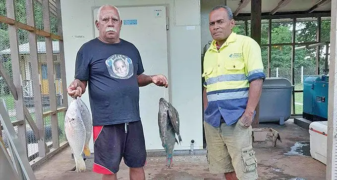 From left: Ilisoni Delailoa and fisheries staff member, Amani Besetimoala. He visits the Fisheries Service Centre after every fishing expedition to record his catch data with fisheries officials.