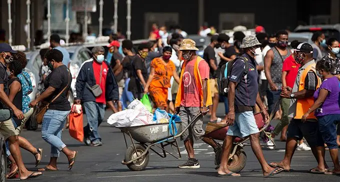 Shoppers and wheelbarrow boys near the Suva Market. Photo: Leon Lord