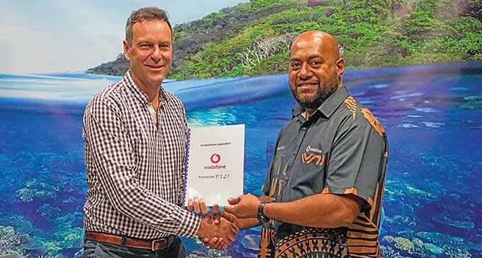 Tourism Fiji chief executive officer Brent Hill (left), with Vodafone Fiji Business Accounts manager Epeli Raivoka.