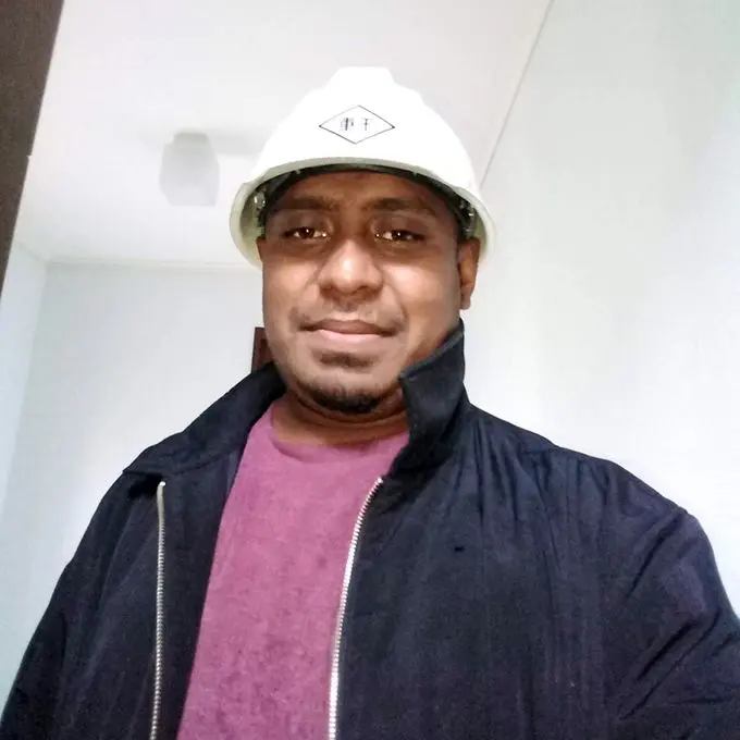 Joseph Sharma, 29, wearing a protective helmet to protect himself from flying debris while checking the cars in the yard and surrounding in Noda City, Chiba, Japan on October 13, 2019.
