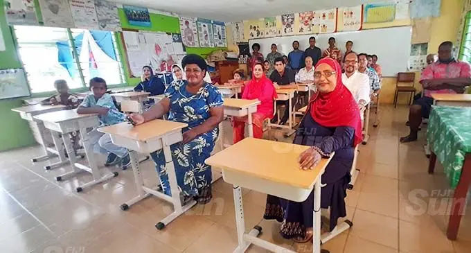 Parents, teachers and donors with the new school desks inside the Year 8 classroom at Rahmatullah Khan Memorial School. Photo: Mereleki Nai