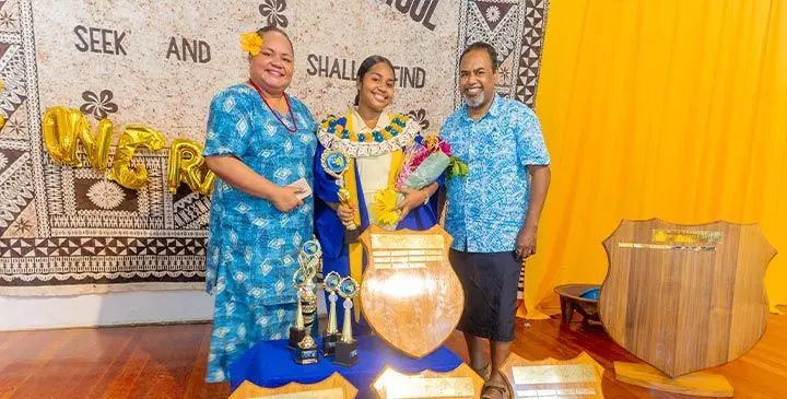 From left, Violet Savu (mother), graduate Edirth Savu and his father Salesi Savu on November 12, 2025. 