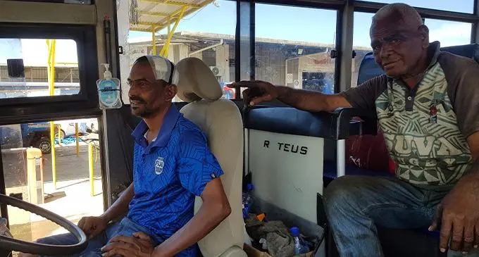Shore Bus Limited chief mechanic Isikeli Raitoakalou (right), showing the covered stitches of his colleague, Sanjay Pratap, at Shore Bus Limited Garage in Lami on September 5, 2022. Photo: Viliame Tawanakoro