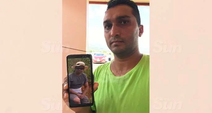 Tashlim Ali at his home in Sabeto, Nadi, on February 22, 2021, holding a picture of his brother, the late Faiz Ali. Photo: Waisea Nasokia