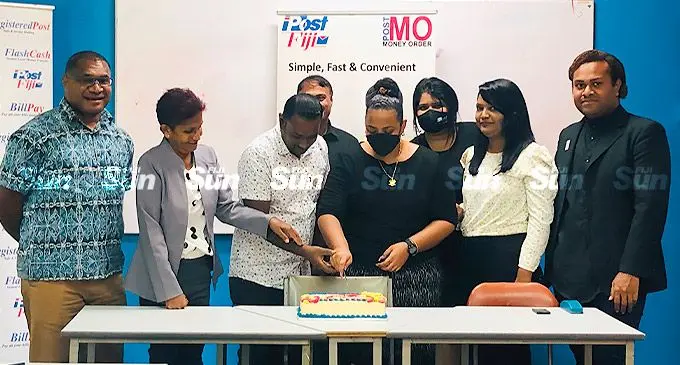 Post Fiji’s head of marketing and retail, Isaac Mow (left), chief executive officer Anirudha Bansod (fourth from left), with call centre staff members and executives on March 3, 2022. Photo: Shreeya Verma
