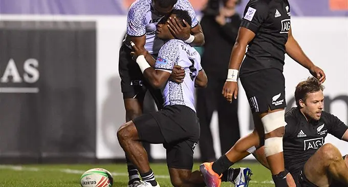 Fiji Airways Fijian 7s winger Aminiasi Tuimaba congratulates halfback Jerry Tuwai after scoring one of his two tries against New Zealand in the Cup quarterfinal of the USA 7s. Photo: Ian Muir