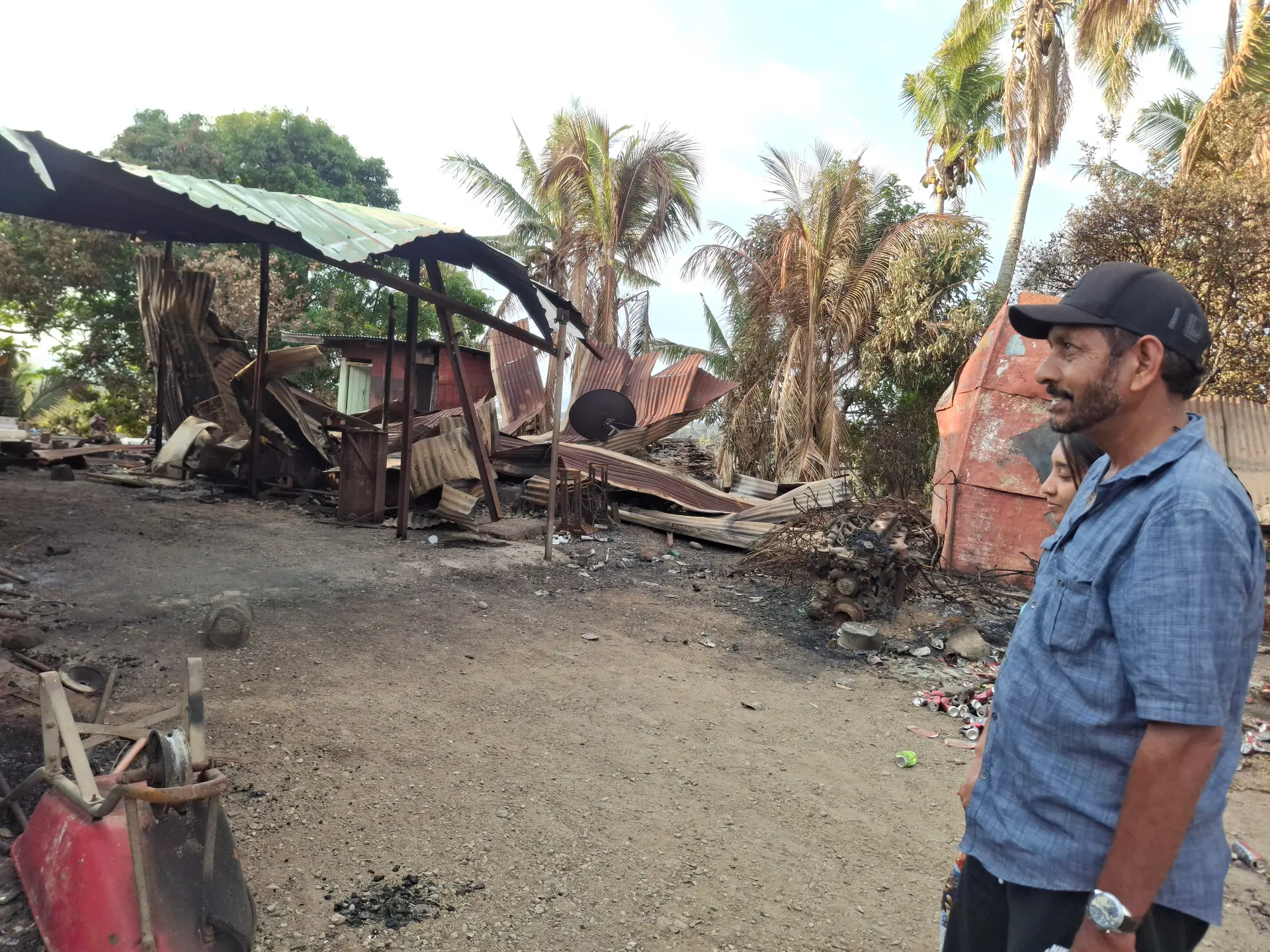 Karim Mohammed looking at his house that was Destroyed by fire last Saturday.