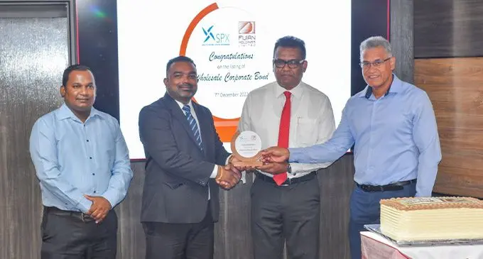(L-R): SPX Acting CEO – Pretesh Prasad, SPX Acting Chairman – Mr Salvin Nand, FHL Acting Chairman – Yogesh Karan and FHL Group CEO – Jaoji Koroi, during Plaque presentation at the Wholesale Corporate Bond listing ceremony 63 students passed out from the centre. Photo: Supplied
