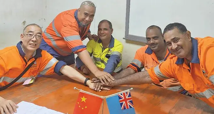 Putting their hands together with Vatuykoula Gold Mines Limited's new General manager, Jiangwu Li, are Onisimo Fonmanu, Saten Singh, Neel Ratnam and Edwin Bhurrah. Photo: Frederica Elbourne