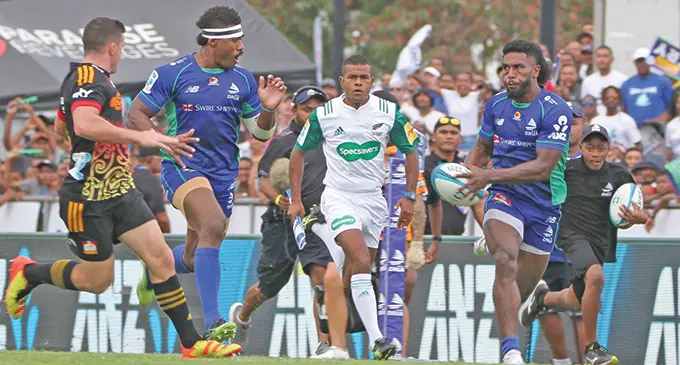 Swire Shipping Fijian Drua halfback Frank Lomani (with ball) is supported by winger Vinaya Habosi in the Super Rugby Pacific clash against Chiefs at Lautoka’s Churchill Park on May 28, 2022. Behind them is Tevita Rokovereni, who became the first Fijian to be a Super Rugby match official. Photo: Waisea Nasokia