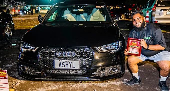 Ashyl Gosai in front of his car.