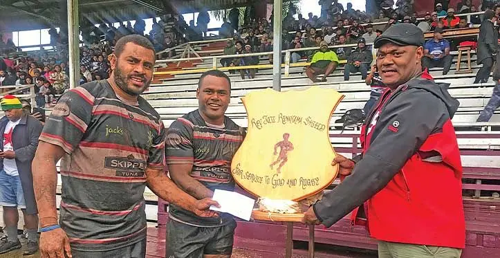 Former Naitasiri rugby captain Apisai Rinamalo (right) hands over the Reverend Jioji Rinakama Shield and $500 prize money to Filimoni Seru at Kini Douglas at Ratu Cakobau Park, Nausori, on August 5, 2023. Photo: Sereana Salalo