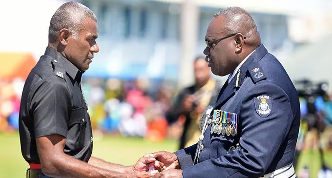  Acting Police Commissioner Rusiate Tudravu (right) awards basic recruit passing out parade Baton of Honour to Jonetani Ratu on September 11, 2020. Photo: Ronald Kumar