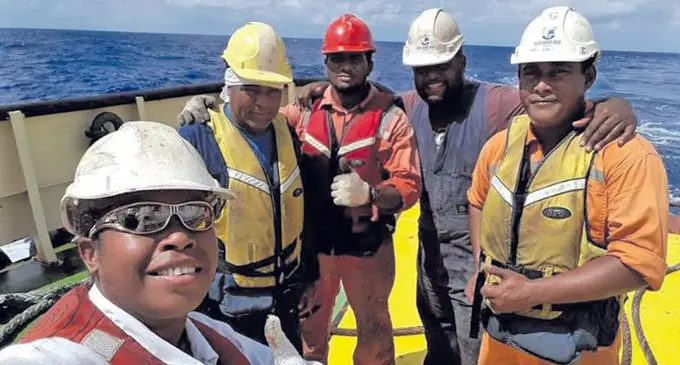 Asena Sitela, left, with her fellow South Seas Towage Ltd workmates out at sea