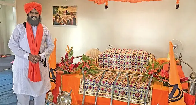 Head Priest Bhai Pritam Singh Shokar serving the Guru Granth Sahib at the Samabula Sikh Temple. Photo: Neelam Prasad