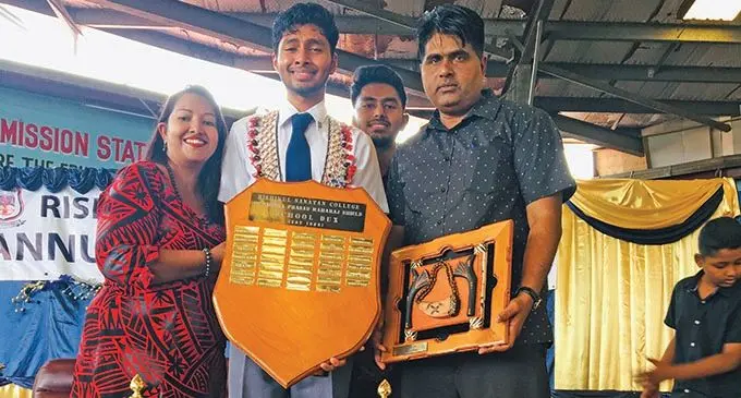 Rishikul Sanatan College dux Mohammed Al-Dousary (middle), with mum Shabnam Khaiyum (left), brother Mohammed Ayala and dad Mohammed Khaiyum during the annual prizegiving ceremony in Nasinu on November 20, 2019.  Photo: Renu Radhika
