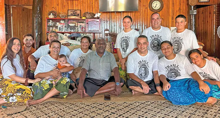 A photo of the Scottish decedents of Sailor Captain James Traill sat cross-legged together on the floor of a room.