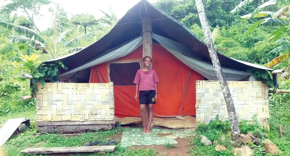 Maca Loaloa infront of her makeshift tent home