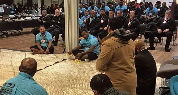 Flying Fijians (seating on the floor, from left) manager Willie Baleinabuli and captain Levani Botia during traditional welcoming ceremony by the Fijian community in Christchurch, New Zealand, on July 3, 2021