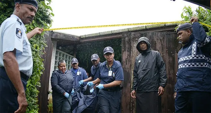 Police remove the body of one of the couple found dead at their home in Lami. Photo: Ronald Kumar