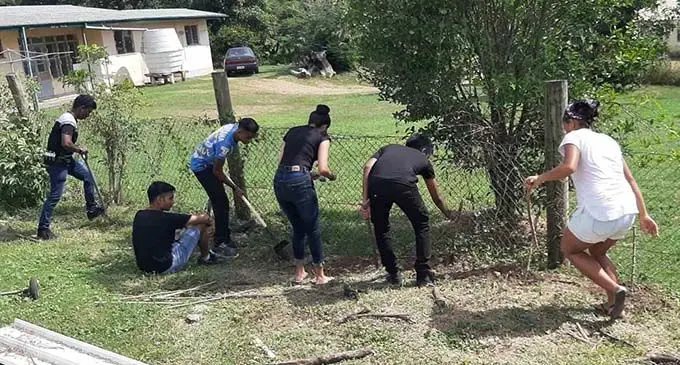 Inari Fiji members clearing and planting at Nadi Hospital during their gardening project.  