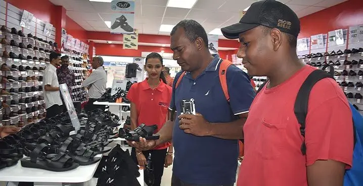 Mataiasi Tuilevu with his son, Michael Cook shopping at Deluxe Footwear in Nadi Town. Photo: Mereleki Nai